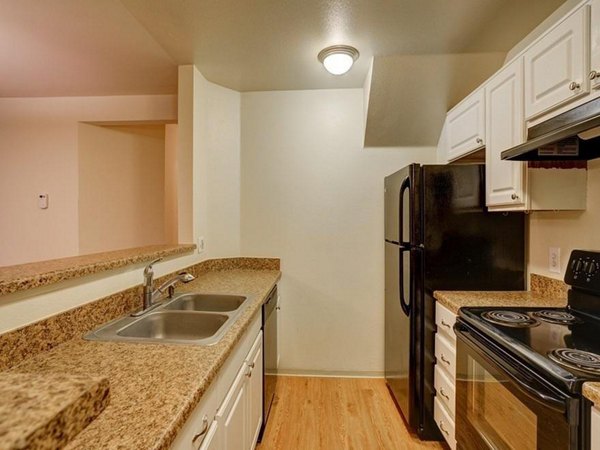 Modern kitchen with stainless steel appliances at The View on 26th Apartments