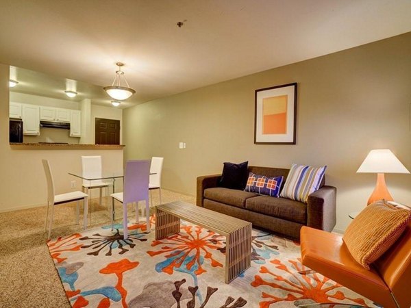 Spacious modern living room with city views at The View on 26th Apartments, luxury residences by Greystar
