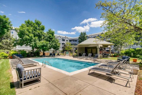 Elevated outdoor pool with city skyline views at The View on 26th Apartments, offering luxury amenities for residents
