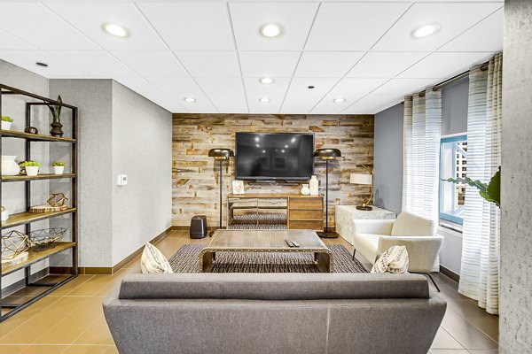 Clubhouse lobby with modern decor and seating at One Superior Place Apartments in Chicago