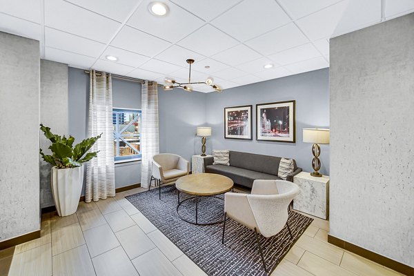 Clubhouse featuring modern seating and lighting at One Superior Place Apartments in Chicago