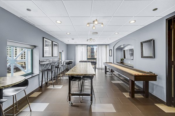 Clubhouse lobby featuring modern decor and ample seating at One Superior Place Apartments in Chicago