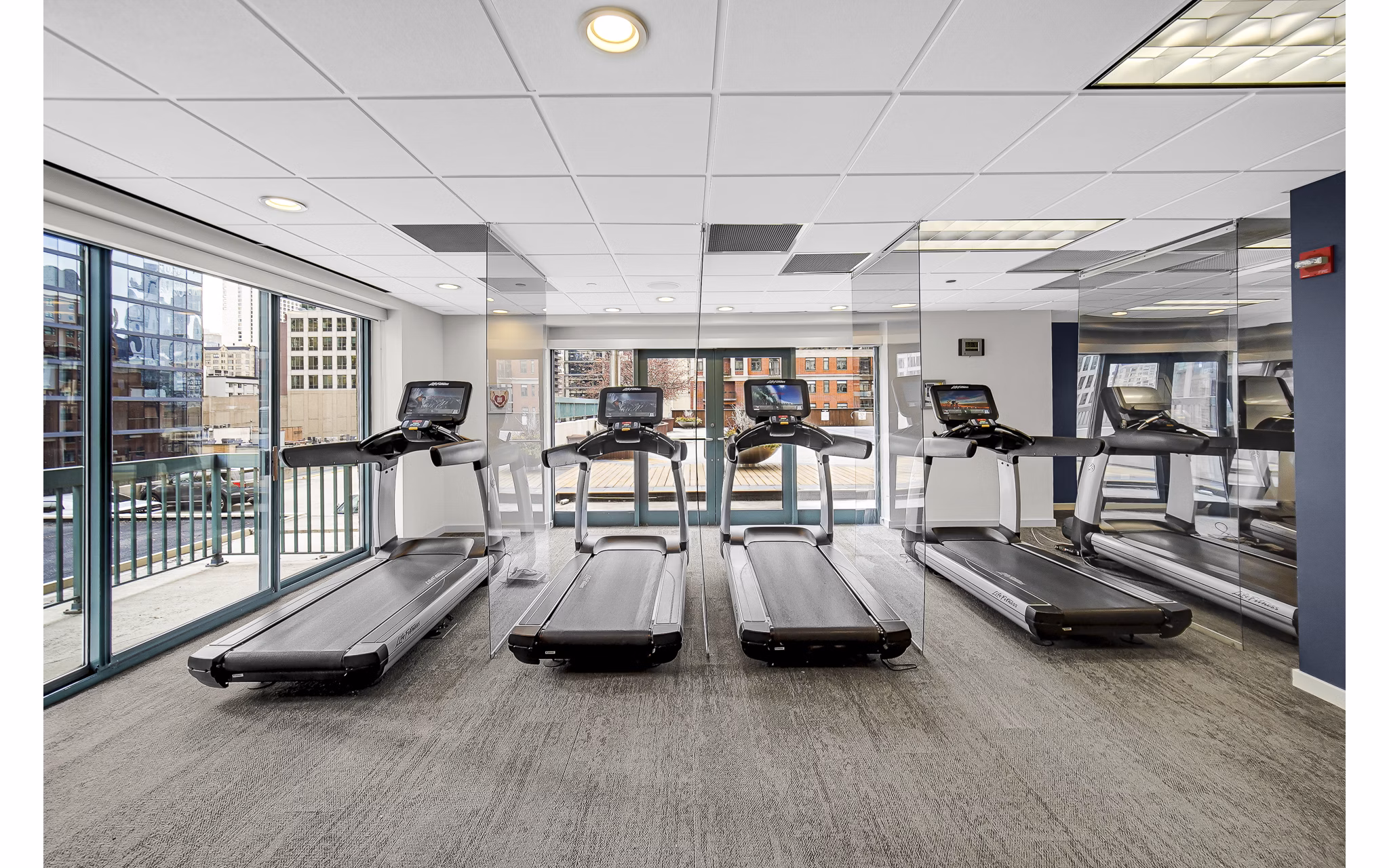 fitness center at One Superior Place Apartments