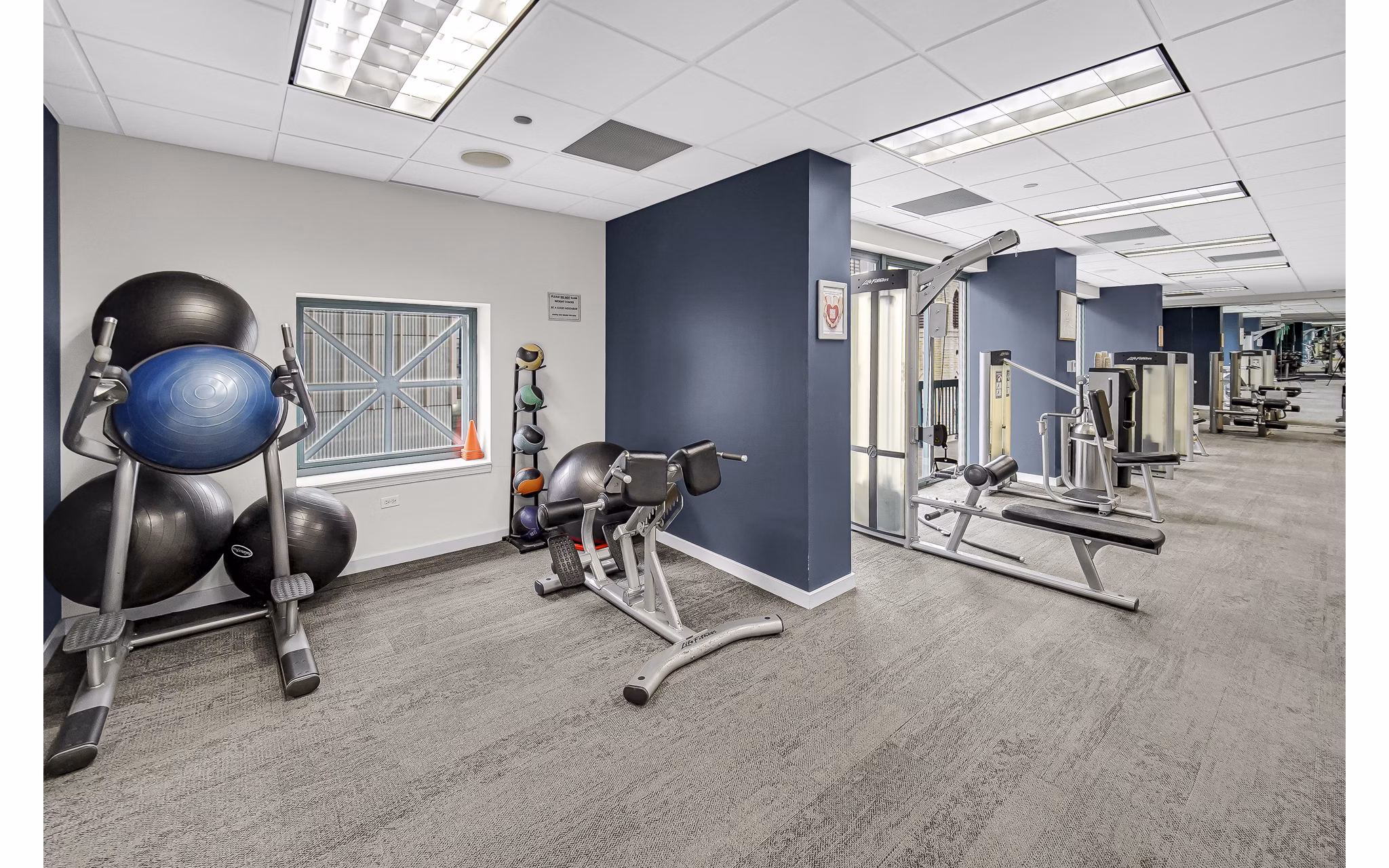 fitness center at One Superior Place Apartments