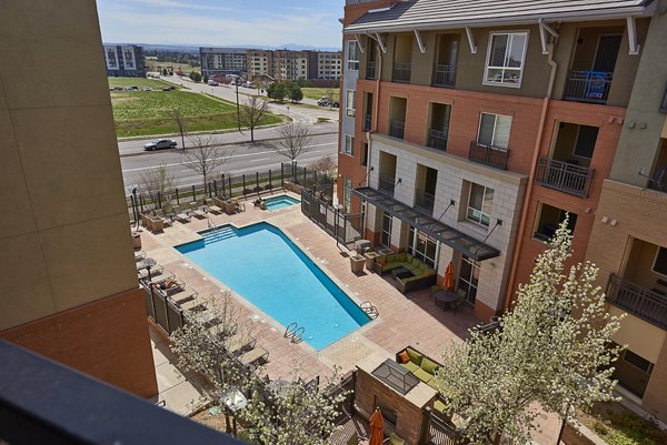 Luxurious swimming pool at Cielo Apartments with lounge chairs and city views