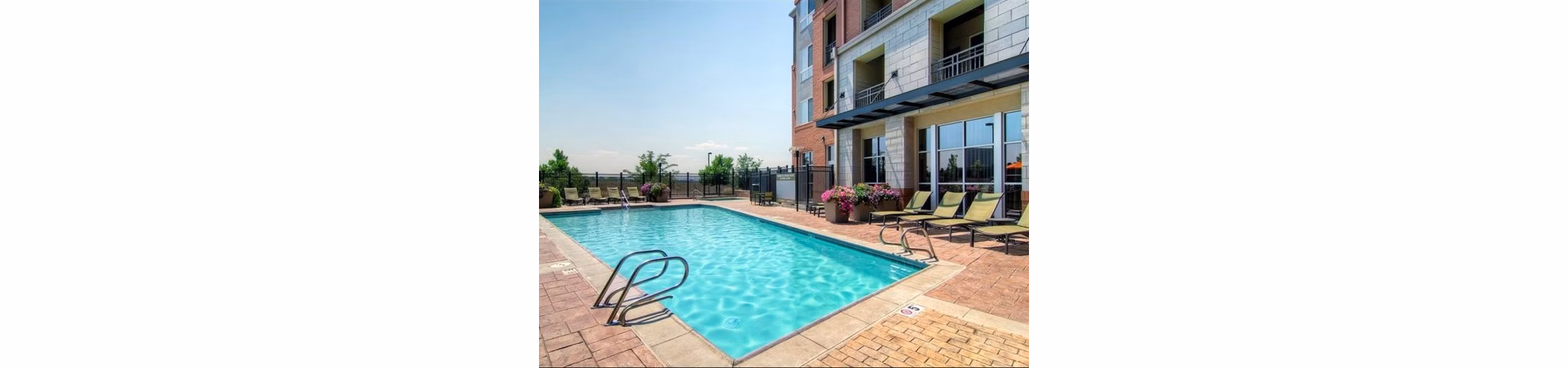 Relaxing pool area with sleek lounge chairs at Cielo Apartments, a luxury Greystar property offering upscale amenities in a vibrant community