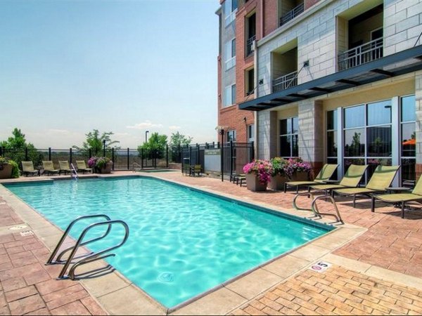 Relaxing pool area with sleek lounge chairs at Cielo Apartments, a luxury Greystar property offering upscale amenities in a vibrant community