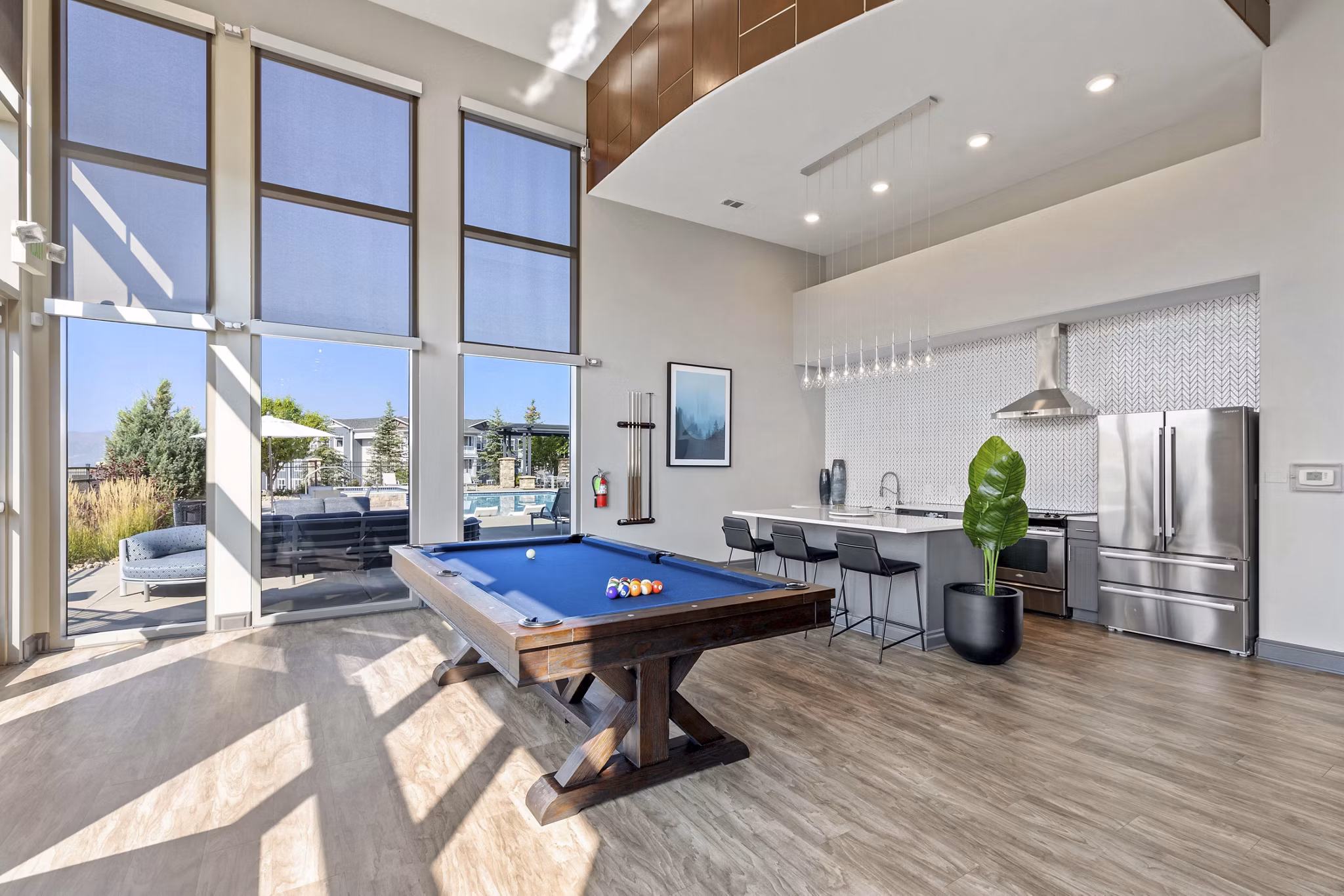 Modern clubhouse with cozy seating and large TV screens at Vue 21 Apartments, ideal for relaxing and socializing in style