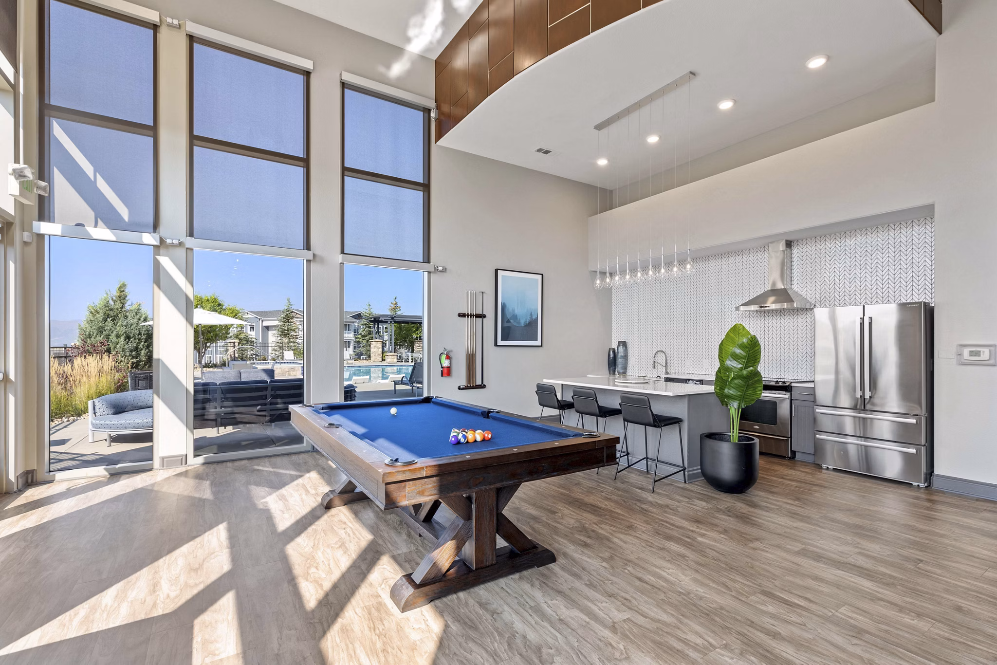 Modern clubhouse with cozy seating and large TV screens at Vue 21 Apartments, ideal for relaxing and socializing in style