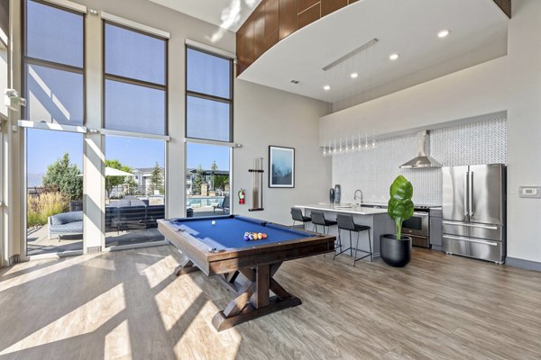 Modern clubhouse with cozy seating and large TV screens at Vue 21 Apartments, ideal for relaxing and socializing in style
