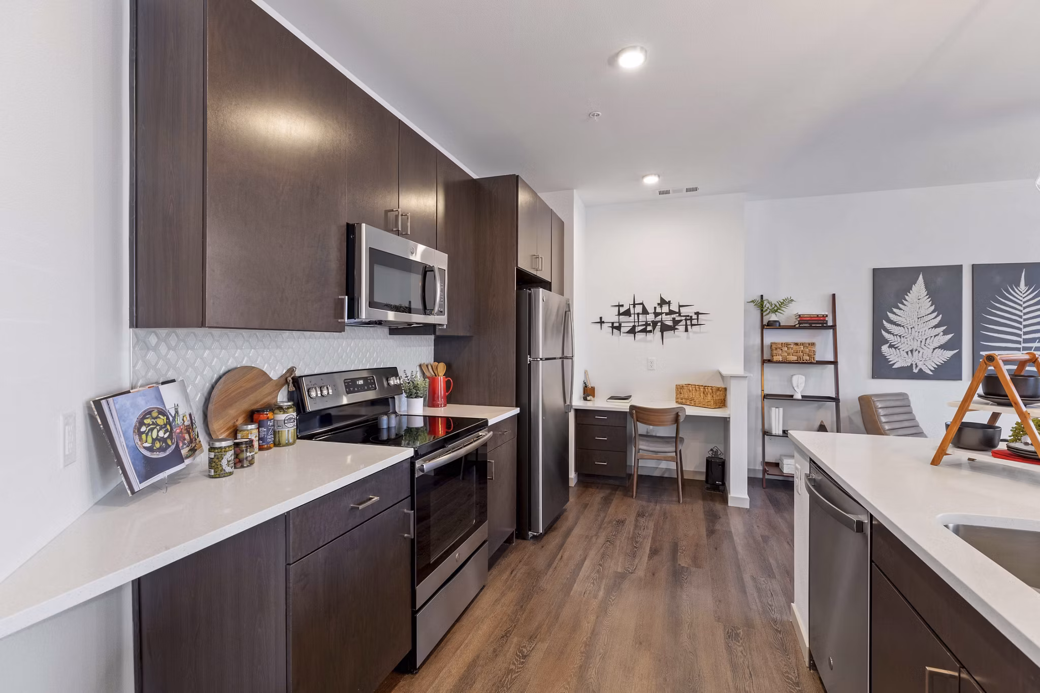 Modern kitchen with stainless steel appliances and granite countertops at Vue 21 Apartments, a Greystar luxury living community