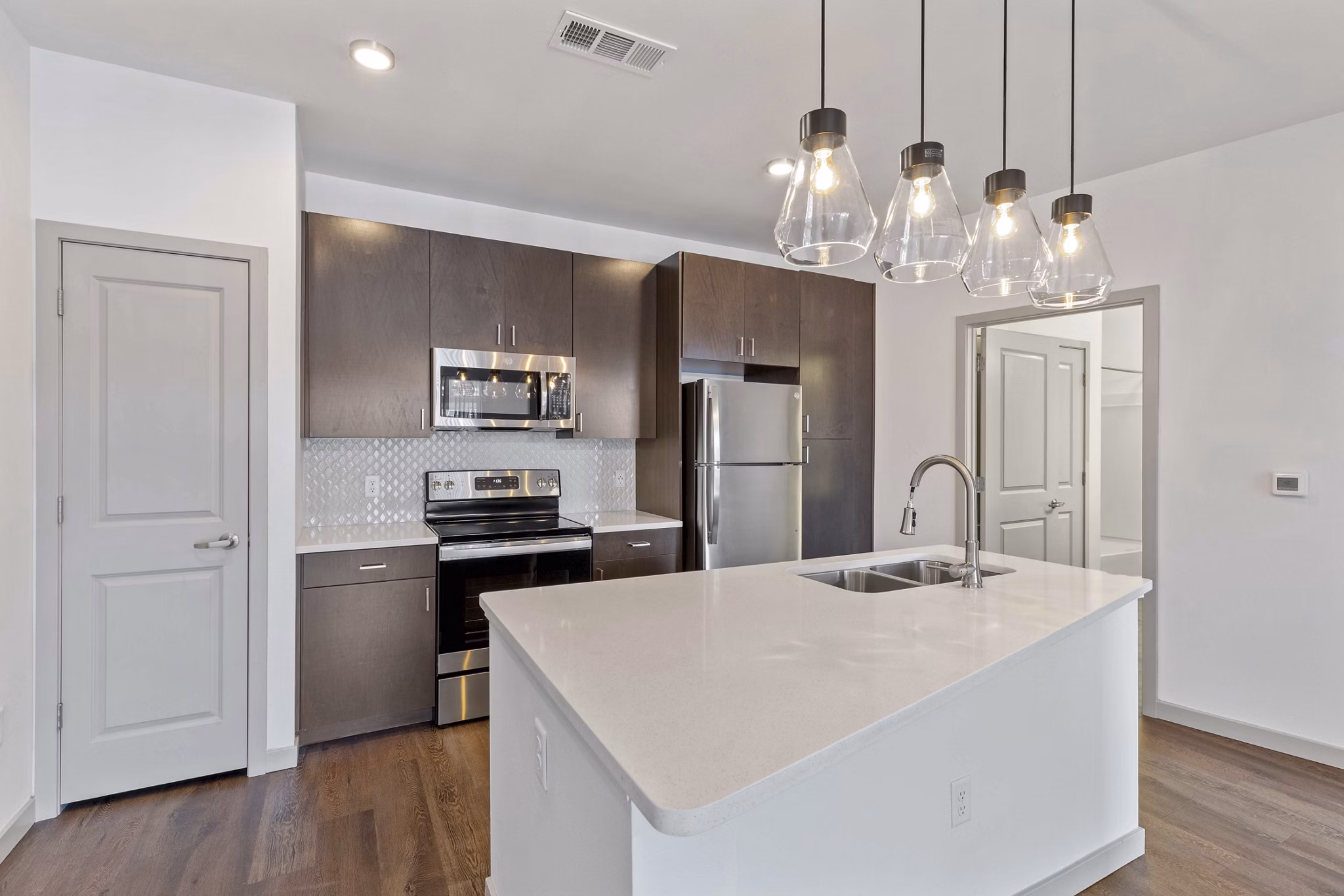 Modern kitchen with stainless steel appliances at Vue 21 Apartmentsâ€”luxury living in a vibrant community setting