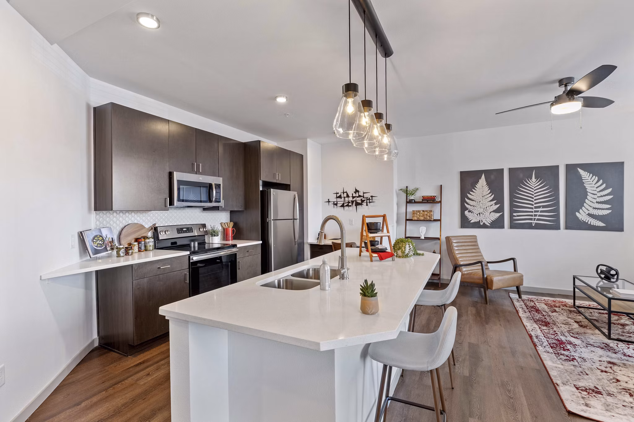 Modern kitchen with sleek countertops and stainless steel appliances in Vue 21 Apartments, luxury living in Colorado Springs