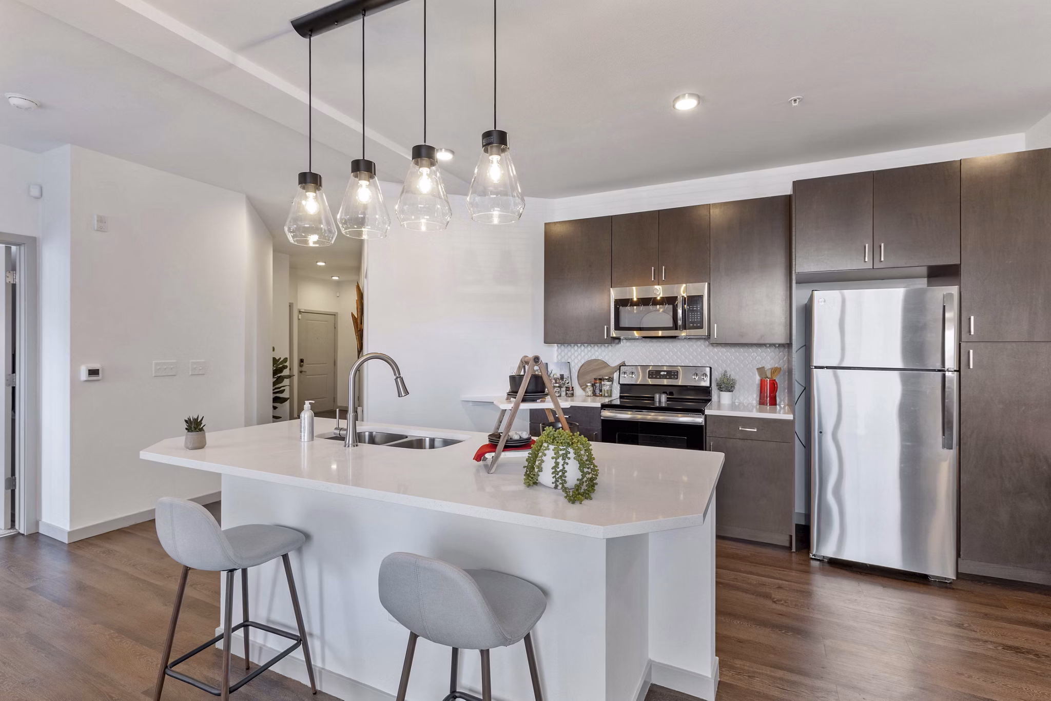 Modern kitchen with stainless steel appliances at Vue 21 Apartments