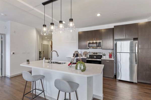 Modern kitchen with stainless steel appliances at Vue 21 Apartments