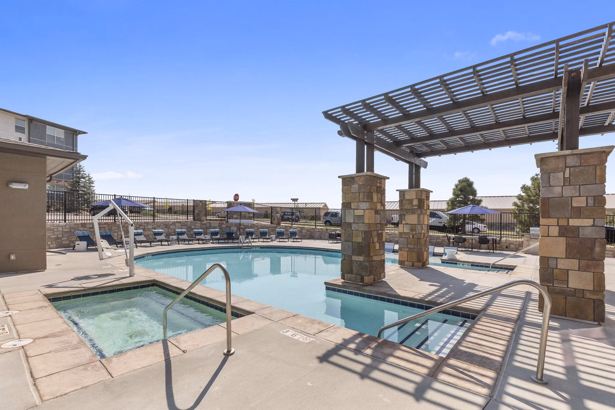 Relaxing poolside at Vue 21 Apartments featuring modern amenities and scenic views