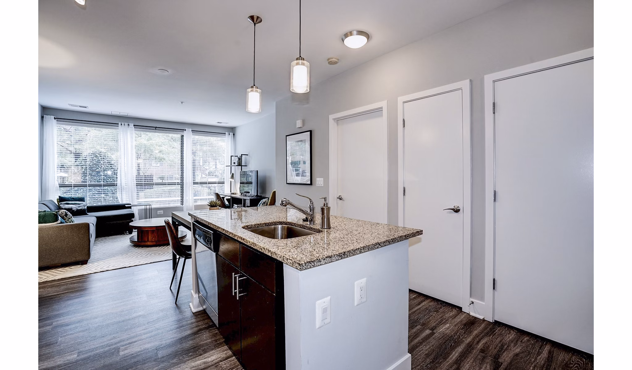 Modern kitchen with stainless steel appliances and island at Del Ray Central Apartments, an offering from Greystar luxury residences