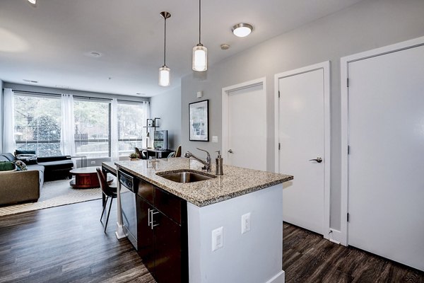 Modern kitchen with stainless steel appliances and island at Del Ray Central Apartments, an offering from Greystar luxury residences