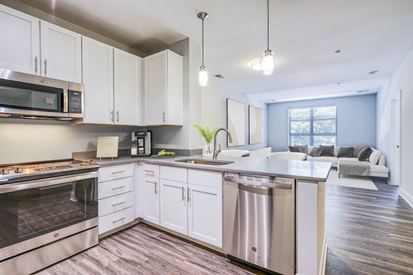 Contemporary kitchen with modern appliances at Del Ray Central Apartments