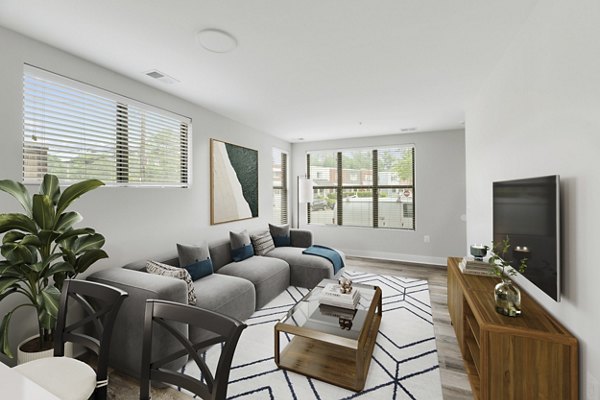 Spacious living room with modern decor in Del Ray Central Apartments