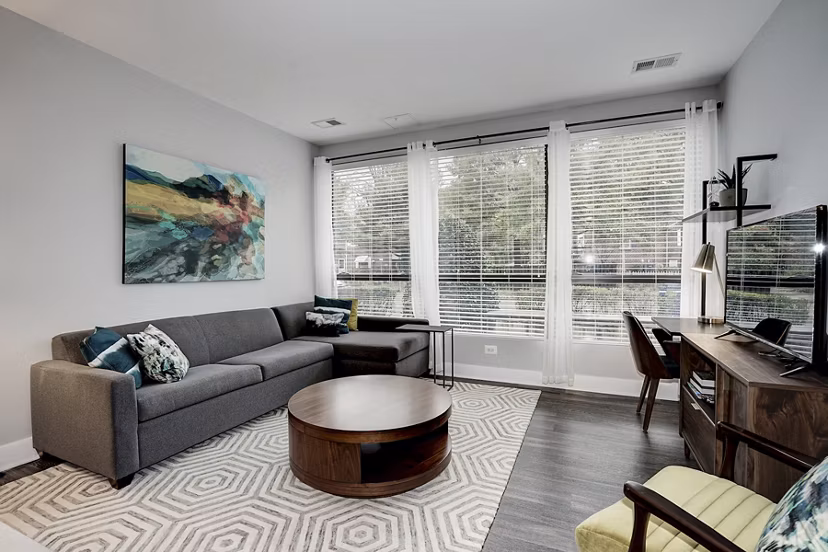 Spacious living room with modern decor and natural light in Del Ray Central Apartments