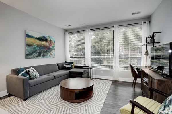 Spacious living room with modern decor and natural light in Del Ray Central Apartments