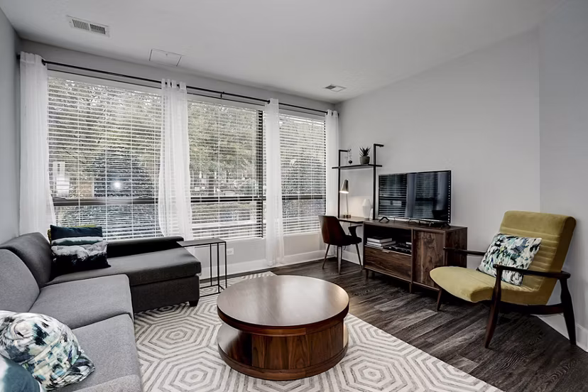 Cozy living room with modern furnishings and natural light at Del Ray Central Apartments, ideal for relaxation and entertaining guests