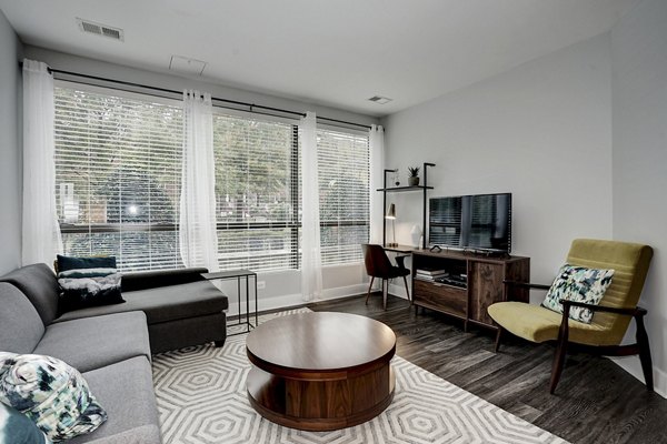 Cozy living room with modern furnishings and natural light at Del Ray Central Apartments, ideal for relaxation and entertaining guests