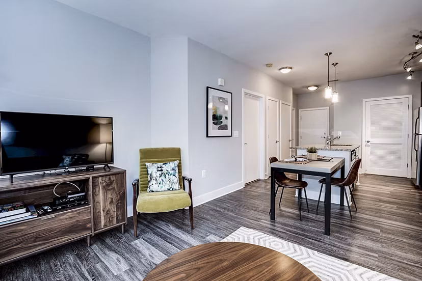 Spacious living room with modern furnishings and natural light in Del Ray Central Apartments