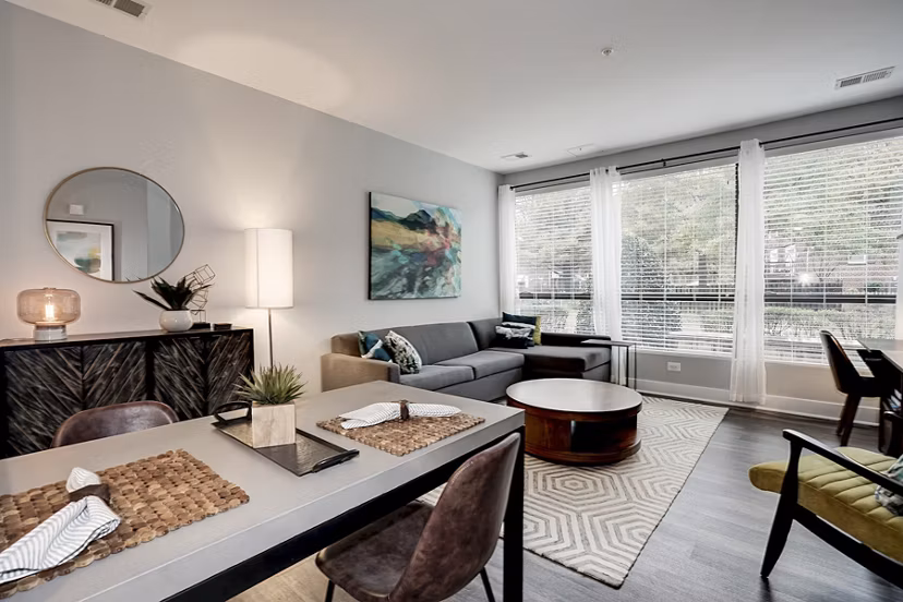 Modern living room with sleek furniture and large windows at Del Ray Central Apartments