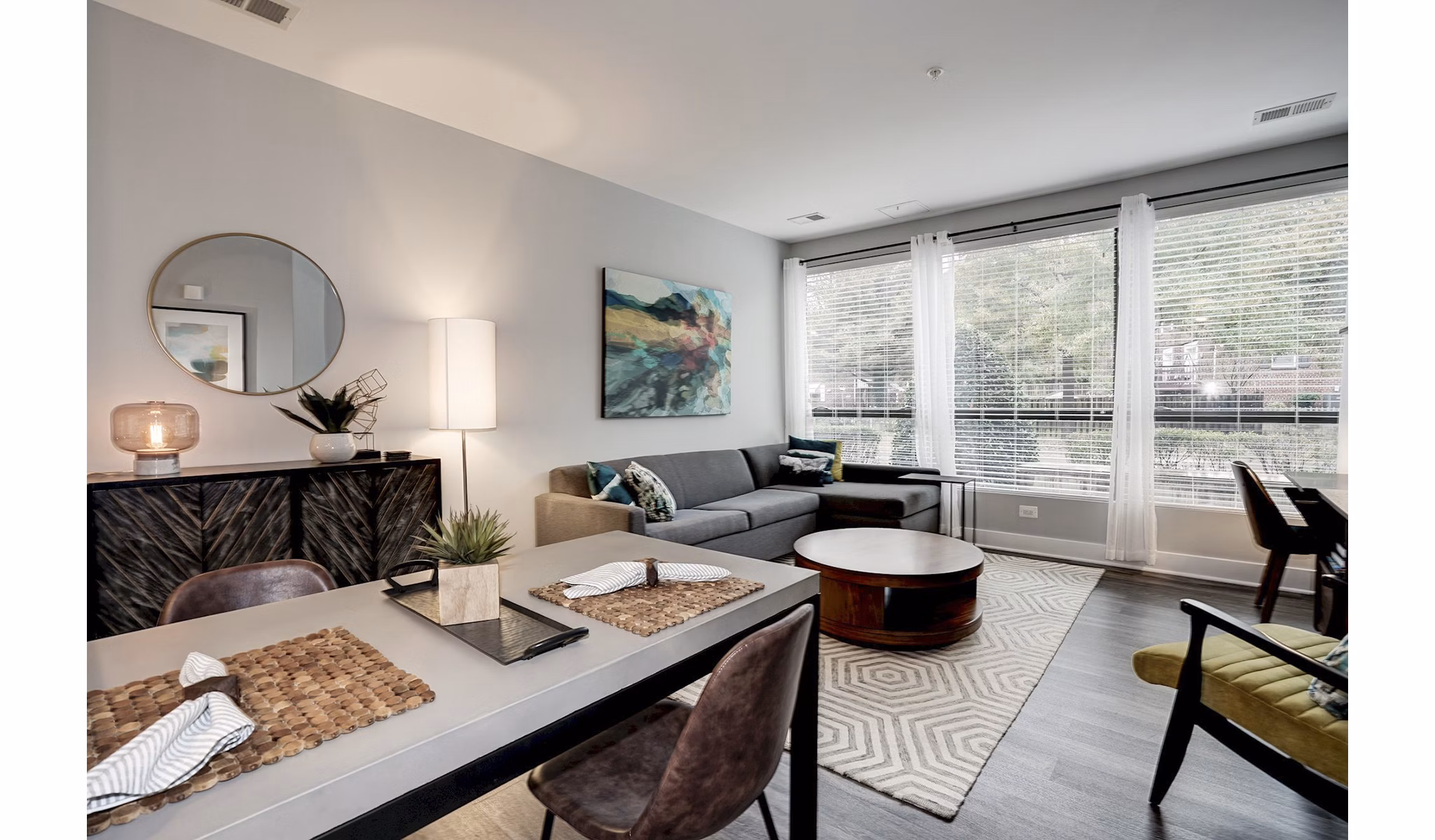 Modern living room with sleek furniture and large windows at Del Ray Central Apartments