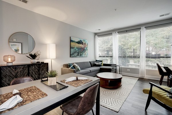 Modern living room with sleek furniture and large windows at Del Ray Central Apartments