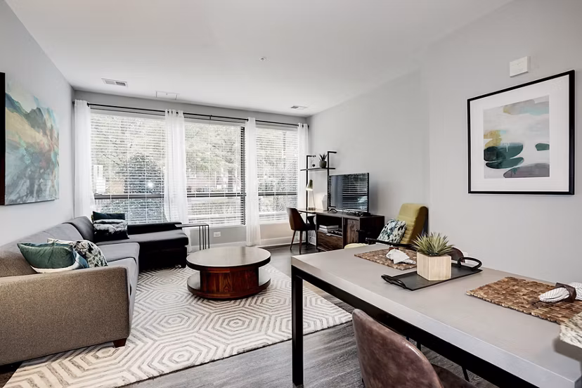 Spacious living room with modern furnishings and natural light at Del Ray Central Apartments