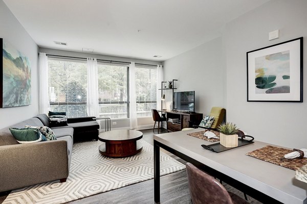 Spacious living room with modern furnishings and natural light at Del Ray Central Apartments