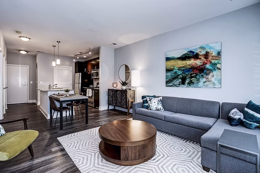 Spacious living room with modern decor in Del Ray Central Apartments