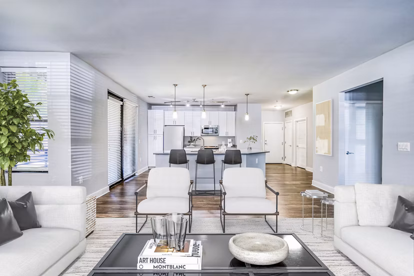 Contemporary living room with cozy seating and large windows at Del Ray Central Apartments, ideal for luxury living in a vibrant community