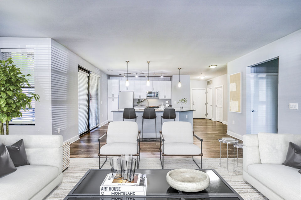 Contemporary living room with cozy seating and large windows at Del Ray Central Apartments, ideal for luxury living in a vibrant community