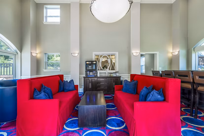 Clubhouse featuring a cozy lounge area at Village at Fox Point Apartments