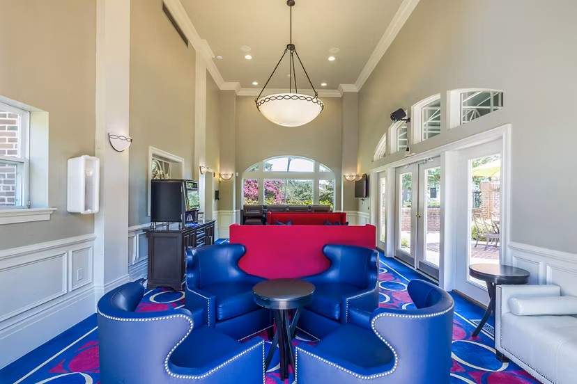 Clubhouse featuring modern design and cozy seating at Village at Fox Point Apartments