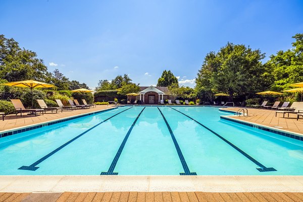 Relaxing outdoor pool area at Village at Fox Point Apartments, perfect for summer leisure activities and luxurious living