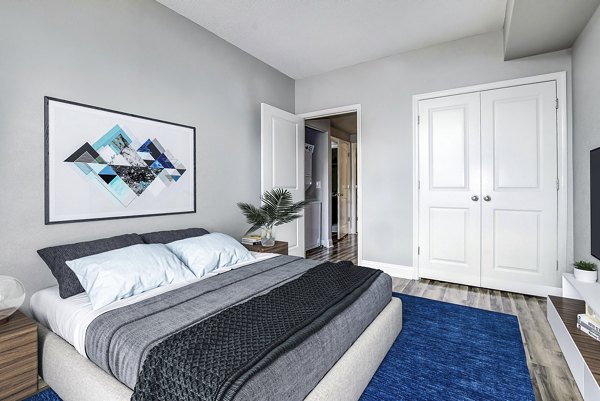 Cozy bedroom with modern furnishings in Massachusetts Court Apartments luxury Greystar community