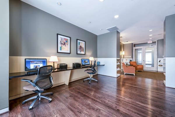 Modern business center featuring two workstations with computers and artwork in a stylish workspace