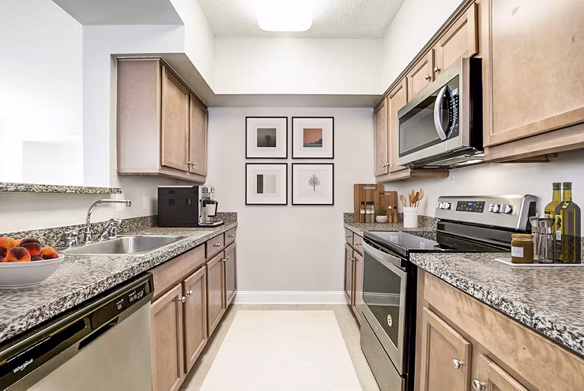 Modern kitchen with stainless steel appliances at Massachusetts Court Apartments