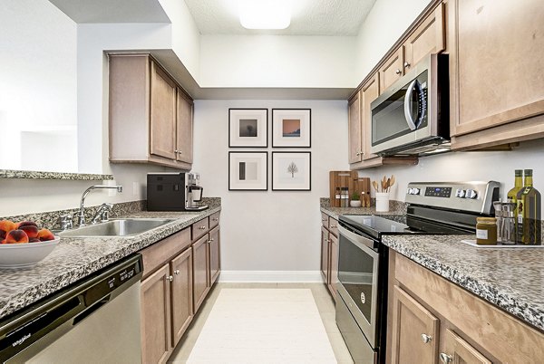 Modern kitchen with stainless steel appliances at Massachusetts Court Apartments