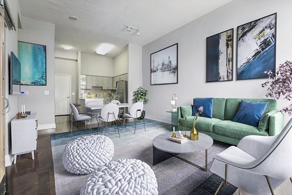 Spacious living room with sleek furniture and natural light in Massachusetts Court Apartments