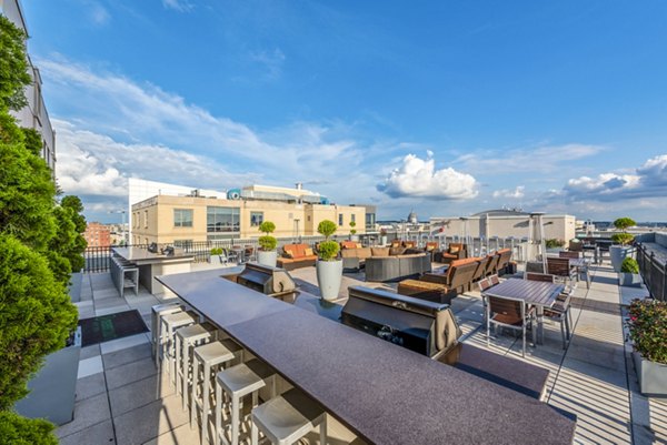 Rooftop terrace with seating areas and planters at luxury apartments
