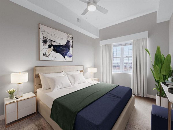 Cozy bedroom with elegant furnishings at The Hawthorne Apartments