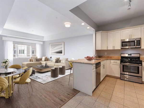 Spacious living area with modern design and hardwood flooring at The Hawthorne Apartments