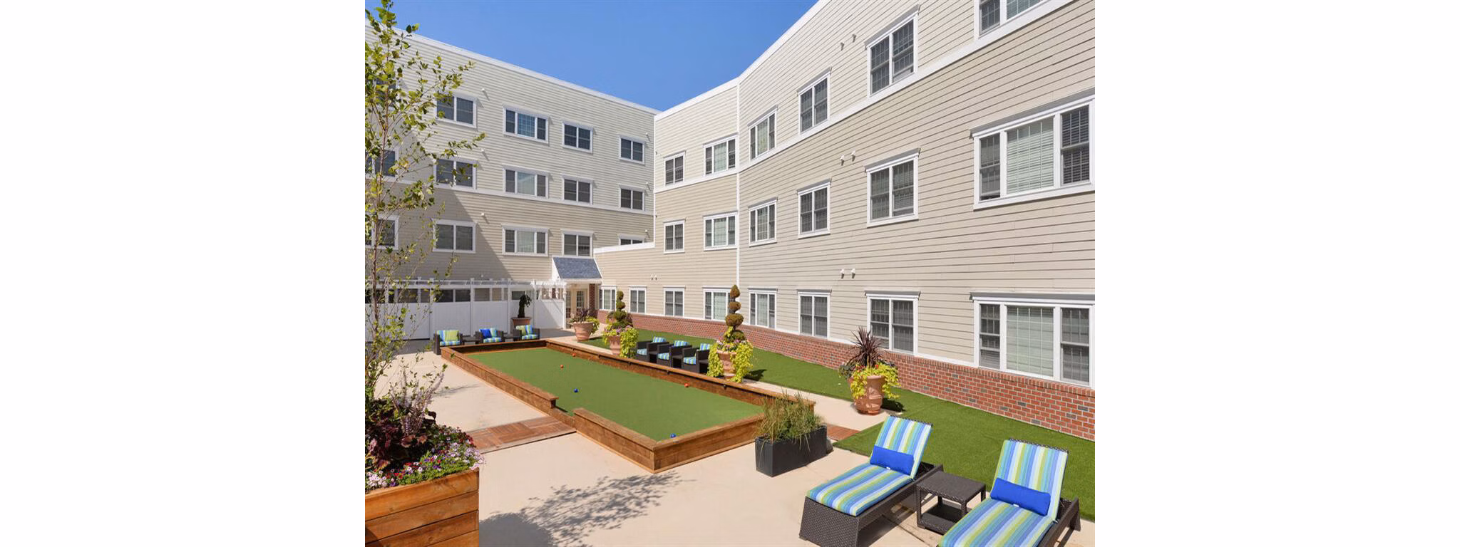 Courtyard featuring lush gardens and seating areas at The Hawthorne Apartments