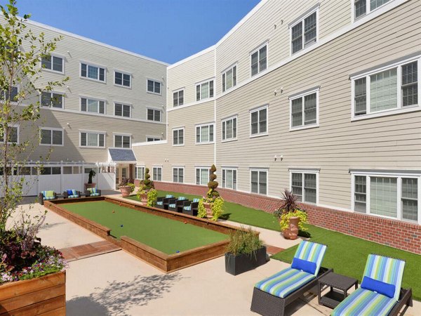 Courtyard featuring lush gardens and seating areas at The Hawthorne Apartments